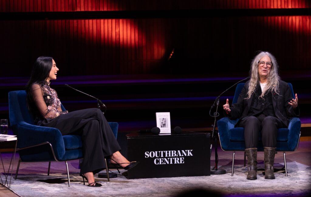 Patti Smith tells Dua Lipa bout her “book of gratitude” ‘Bread Of Angels’ at emotional London Literature Festival appearance: “I swore I’d never write another memoir”